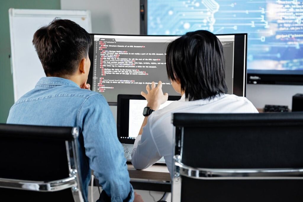 a man & woman using pc software devloping